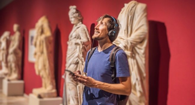 A curious visitor exploring a museum with headphones